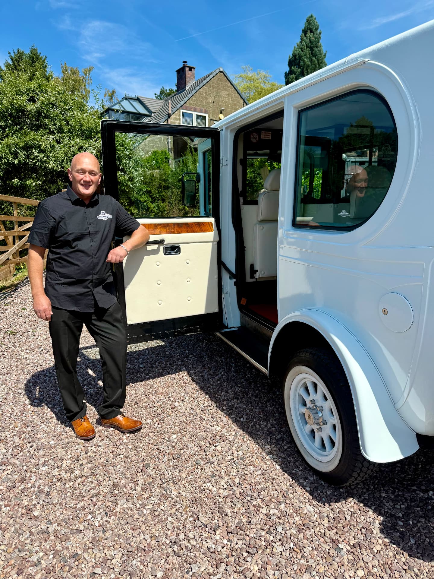 Gordon beside the open door of the Frozen White Asquith wedding car