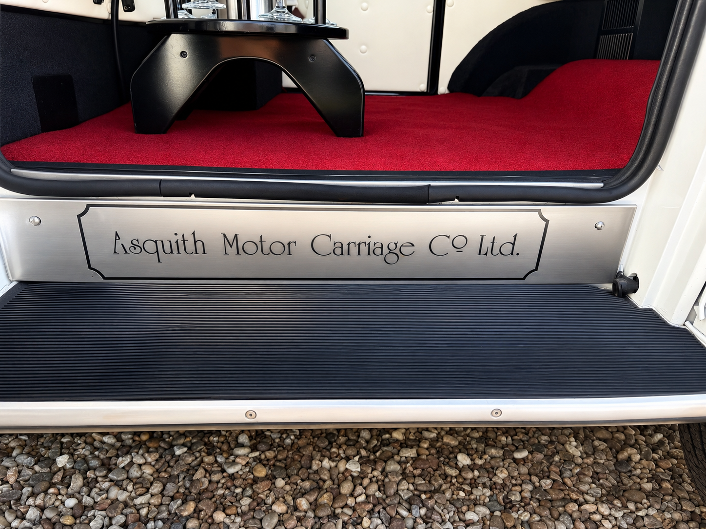 Polished Asquith Motor Carriage Co Ltd sill plate and red carpeted step